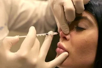 ALEXANDER RIVKIN, MD, PERFORMS A NON-SURGICAL NOSE JOB, A PROCEDURE HE SAYS HE PIONEERED.