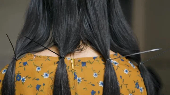 A 16-YEAR-OLD STUDENT IN VIETNAM SELLS HER HAIR TO AFFORD HER SCHOOL FEES.